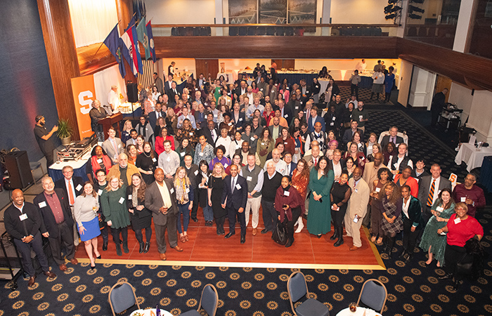 Crowd of guests at 2023 holiday celebration taken from above in a balcony